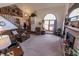 Open-concept living area with cozy seating, fireplace, staircase to loft, and large windows at 3819 S Village Dr, New Palestine, IN 46163