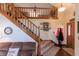 View of the entryway and staircase leading to the second floor with wood railings at 3819 S Village Dr, New Palestine, IN 46163