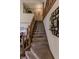 Carpeted staircase with wooden railing and decorated walls leading to the upper level at 3819 S Village Dr, New Palestine, IN 46163