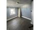 Bedroom featuring a window, light gray walls and wood-look flooring at 409 Parkway Ave, Indianapolis, IN 46225