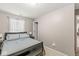 Neutral bedroom features a black bed frame, soft carpet, and natural light from the window at 4167 Apple Creek Dr, Indianapolis, IN 46235