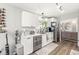 Functional kitchen featuring stainless steel appliances, white cabinetry, and a view to the living space at 4167 Apple Creek Dr, Indianapolis, IN 46235