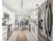 Bright kitchen featuring modern appliances, white cabinetry, hardwood floors, and an adjacent dining area at 4167 Apple Creek Dr, Indianapolis, IN 46235