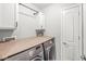 Clean laundry room features modern machines, ample counter space, and storage cabinets at 4167 Apple Creek Dr, Indianapolis, IN 46235