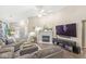 Well-lit living room with hardwood floors, a fireplace, and comfortable seating, creating a welcoming atmosphere at 4167 Apple Creek Dr, Indianapolis, IN 46235