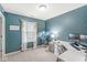 Cozy home office features blue walls, a large window, and a well-lit workspace at 4167 Apple Creek Dr, Indianapolis, IN 46235