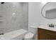 Modern bathroom with stylish tile work, new vanity, and a bathtub at 4230 Kingsley Dr, Indianapolis, IN 46205