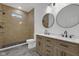 A spacious bathroom showcasing a double vanity, and a tiled walk-in shower at 4230 Kingsley Dr, Indianapolis, IN 46205