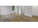 Spacious bedroom with natural light, white walls, and stylish wood-look floors at 4230 Kingsley Dr, Indianapolis, IN 46205