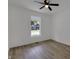 Serene bedroom with modern flooring, a ceiling fan, and a bright window at 4230 Kingsley Dr, Indianapolis, IN 46205