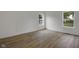A well-lit bedroom offers wood-look flooring and white walls, perfect for creating a calming retreat at 4230 Kingsley Dr, Indianapolis, IN 46205