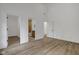 Bright bedroom with wood-look floors leads to an en suite bathroom and closet at 4230 Kingsley Dr, Indianapolis, IN 46205