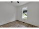 Cozy bedroom featuring modern floors, a bright window, and neutral decor at 4230 Kingsley Dr, Indianapolis, IN 46205