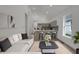 Bright living room with a modern kitchen, comfortable sofa, and contemporary decor at 4230 Kingsley Dr, Indianapolis, IN 46205