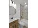 Bright bathroom with modern fixtures and white tub-shower combo with tiled walls at 4234 Kingsley Dr, Indianapolis, IN 46205
