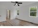 Bedroom with hardwood floors, ceiling fan, and natural light from two windows at 4234 Kingsley Dr, Indianapolis, IN 46205