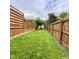 Backyard with grass area enclosed by a modern wood fence for a secure and private outdoor setting at 4625 Woodcrest Dr, Columbus, IN 47203