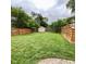 Large grassy backyard, wooden fence, and storage shed at 4625 Woodcrest Dr, Columbus, IN 47203