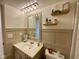 Bathroom with classic vanity, decorative shelves, and modern fixtures for a comfortable feel at 4625 Woodcrest Dr, Columbus, IN 47203