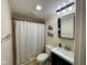 Bathroom with white shower curtain, basic vanity, and compact design maximizing space at 4625 Woodcrest Dr, Columbus, IN 47203