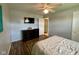 Bedroom featuring a mounted television, dresser, and neutral decor at 4625 Woodcrest Dr, Columbus, IN 47203