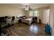 Spacious bedroom with wood-look floors, ceiling fan, and plenty of space for a desk and seating at 4625 Woodcrest Dr, Columbus, IN 47203