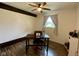 Bedroom with wood-look flooring, a ceiling fan, and a window overlooking the front yard at 4625 Woodcrest Dr, Columbus, IN 47203