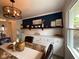 Inviting dining room featuring tiled flooring, ample storage, decor shelving, and natural light from a window at 4625 Woodcrest Dr, Columbus, IN 47203