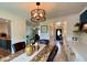 Cozy dining room featuring a stylish light fixture, marble table, and a view into the living area at 4625 Woodcrest Dr, Columbus, IN 47203