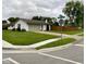 Exterior of a white brick home with a gray roof, green lawn, and a paved driveway at 4625 Woodcrest Dr, Columbus, IN 47203