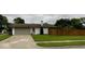 Exterior view of a house with a large front yard and a driveway leading to an attached garage at 4625 Woodcrest Dr, Columbus, IN 47203