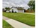 Wide view of home showcasing the lawn, walkway, brick exterior, and attached garage at 4625 Woodcrest Dr, Columbus, IN 47203