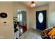 Welcoming foyer features a blue front door and access to a living space with hardwood flooring at 4625 Woodcrest Dr, Columbus, IN 47203