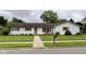 Charming single story home featuring a well maintained lawn, painted brick, and wood trim accents at 4625 Woodcrest Dr, Columbus, IN 47203