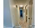 Hallway features tile floors, neutral paint, and access to various rooms at 4625 Woodcrest Dr, Columbus, IN 47203