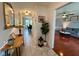 Inviting hallway featuring tile flooring, a decorative mirror, and transitions into the living room and dining area at 4625 Woodcrest Dr, Columbus, IN 47203
