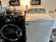 Modern laundry appliances including a front load washer and top load dryer at 4625 Woodcrest Dr, Columbus, IN 47203