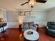 Cozy living room with hardwood floors, stylish furniture, a ceiling fan, and a decorative shelf at 4625 Woodcrest Dr, Columbus, IN 47203