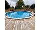Relax by the sparkling in-ground pool surrounded by a wooden deck at 4625 Woodcrest Dr, Columbus, IN 47203