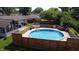 Large above ground pool with surrounding wooden deck and outdoor furniture, perfect for entertaining at 4625 Woodcrest Dr, Columbus, IN 47203