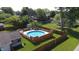 Above-ground backyard pool with wooden deck and a well-manicured lawn at 4625 Woodcrest Dr, Columbus, IN 47203