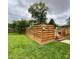 Backyard with a pool area that features a wooden fence and green grass at 4625 Woodcrest Dr, Columbus, IN 47203