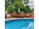 Outdoor dining area with a picnic table next to a pool, great for entertaining guests by the water at 4625 Woodcrest Dr, Columbus, IN 47203