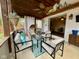 Enjoy the indoor/outdoor living space in this sunroom with hanging plants at 4625 Woodcrest Dr, Columbus, IN 47203