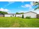 Spacious backyard featuring a large lawn and a white vinyl-sided house at 4640 Autumn Ridge Dr, Columbus, IN 47203