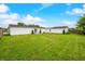Lush backyard with a well-maintained lawn and a white vinyl-sided house at 4640 Autumn Ridge Dr, Columbus, IN 47203