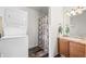 Bathroom featuring a sink, toilet, laundry, and shower at 4640 Autumn Ridge Dr, Columbus, IN 47203