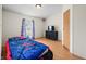 Bright bedroom with a whimsical car-shaped bed and natural light streaming through the window at 4640 Autumn Ridge Dr, Columbus, IN 47203