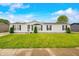 Charming single-story home with a well-manicured lawn and classic white siding at 4640 Autumn Ridge Dr, Columbus, IN 47203