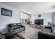 Cozy living room featuring tile floors and comfortable black leather furniture at 4640 Autumn Ridge Dr, Columbus, IN 47203
